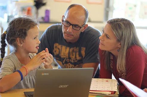 Parents and child learning together at The Source Academy